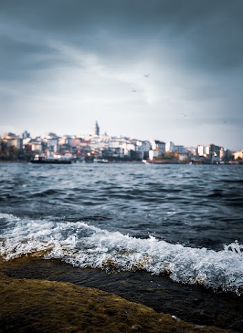 Seashore With City Escape Background