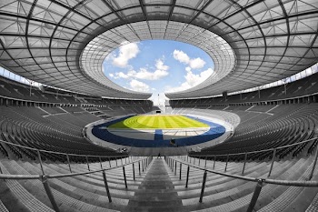Selective Color Photography of Person at Soccer Stadium during Daytime