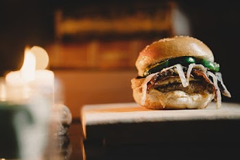 Selective Focus Close-up Photo of Hamburger on Wooden Chopping Board
