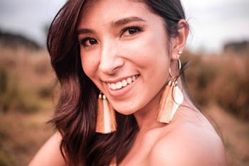 Selective Focus Close-up Photo of Smiling Woman Wearing Tassel Earrings