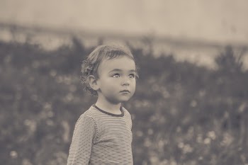 Selective Focus Grayscale Photo of Boy Looking Up