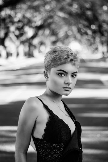 Selective Focus Grayscale Photography of Woman Posing in the Middle of a Road