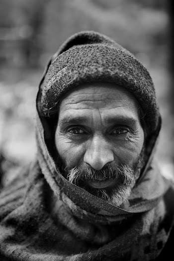 Selective Focus Grayscale Portrait Photo of Elderly Man in Beanie and Scarf Over His Head