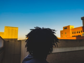 Selective Focus of Man Wearing Blue Crew-neck Top
