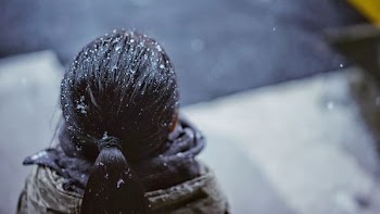 selective focus of person with snow droplets on hair