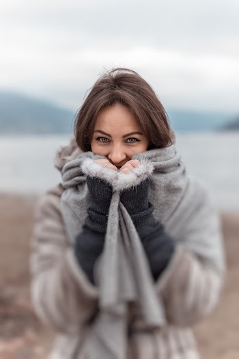 Selective Focus Of Woman Covering Mouth With Scarf