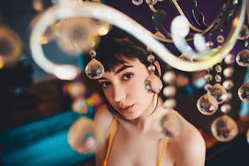 Selective Focus of Woman Near Crystal Chandelier