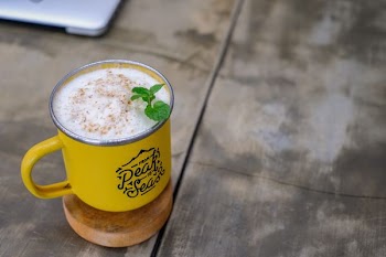 selective focus of yellow mug with white liquid