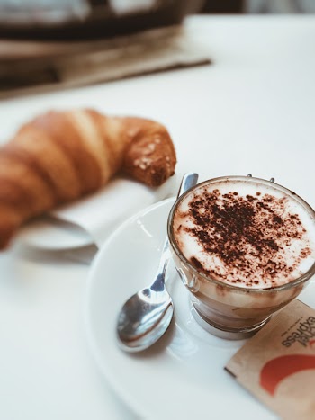 Selective Focus Photo of a Cup Filled With Coffee on White Ceramic Saucer