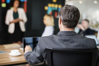 Selective Focus Photo of a Man Sitting