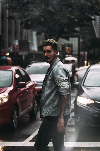 Selective Focus Photo of a Man Wearing Grey Jacket on the Road