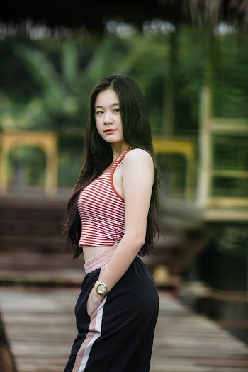 Selective focus photo of a woman wearing red and white striped tank top