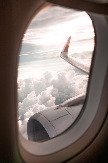 Selective Focus Photo of Airplane Window