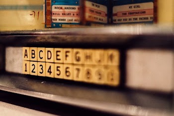 selective focus photo of alphabet and latter tile