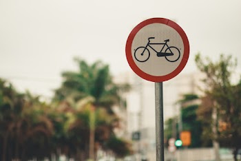 Selective Focus Photo of Bicycle Road Sign