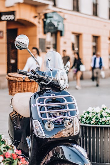 Selective Focus Photo of Black and Brown Motor Scooter