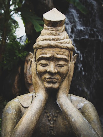 Selective Focus Photo of Buddha Statue