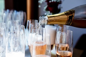 Selective Focus Photo of Champagne Pouring in to a Glass
