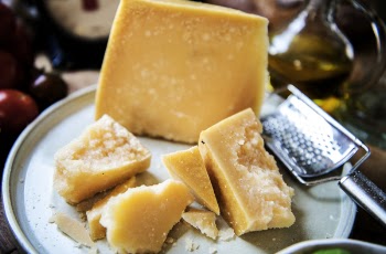 Selective Focus Photo of Cheese and Grater on Plate