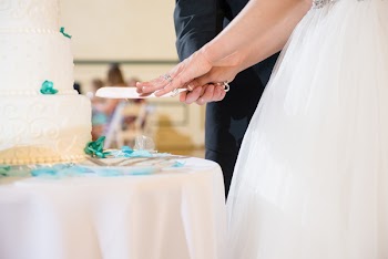 Selective Focus Photo Of Coupe About to Slice A Cake