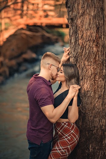 Selective Focus Photo of Couple Kissing By Tree