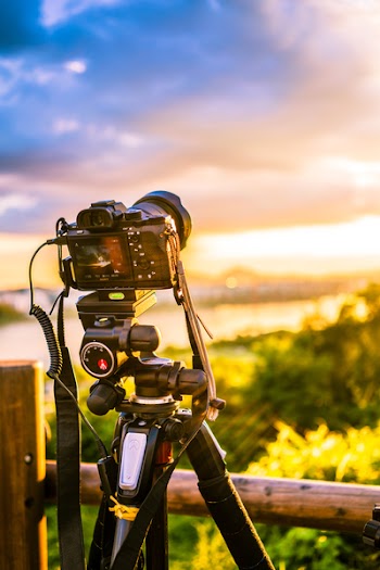 Selective Focus Photo of Dslr Camera With Tripod Stabilizer