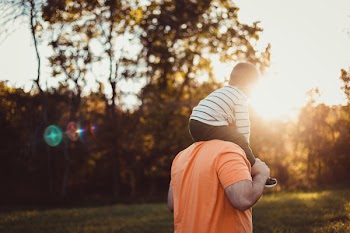 Selective Focus Photo of Father Carrying His Child