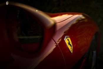 Selective Focus Photo of Ferrari Emblem
