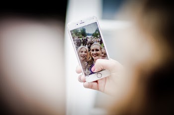 Selective Focus Photo of Gold Iphone 6 Displaying Two Women Taking Selfie
