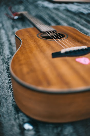 Selective Focus Photo of Guitar