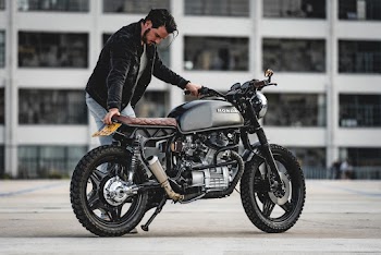 Selective Focus Photo of Man in Black Jacket Parking Black Honda Cafe Racer Motorcycle