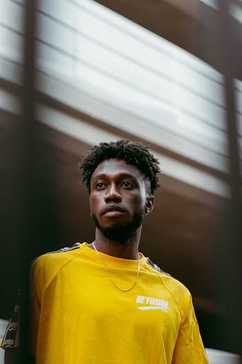Selective Focus Photo of Man in Yellow T-shirt Posing