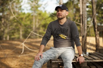 Selective Focus Photo of Man Sitting on Plank