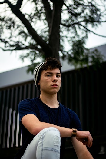 Selective Focus Photo of Man Wearing Knit Cap and Blue T-shirt and Jeans Posing