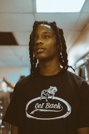 selective focus photo of man wearing white and black crew-neck shirt