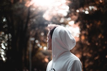 Selective Focus Photo of Man Wearing White Hoodie