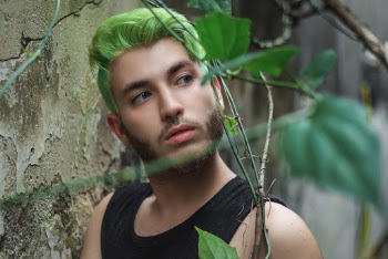 Selective Focus Photo of Man with Green Hair Looking Away