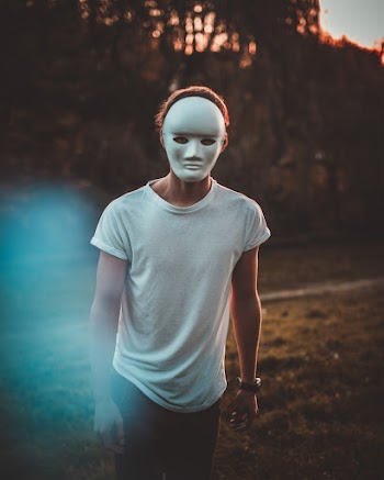 Selective Focus Photo of Masked Man Standing Outdoors