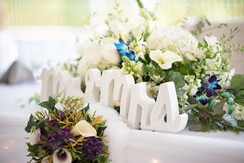 Selective Focus Photo of Mr. &amp; Mrs. Freestanding Letter Surrounded by Flower