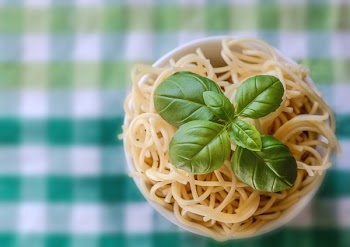 Selective Focus Photo of Noddles With Green Leaf Toppings