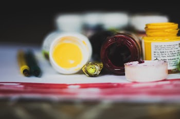 Selective Focus Photo of Opened Paint Containers