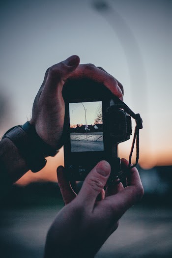 Selective Focus Photo of Person Holding Camera