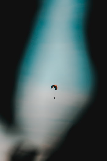 Selective Focus Photo of Person Paragliding