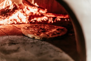 Selective Focus Photo of Pizza in Furnace