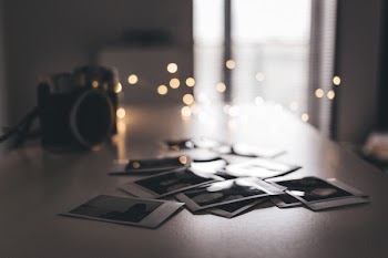 Selective Focus Photo Of Polaroid Films On Table