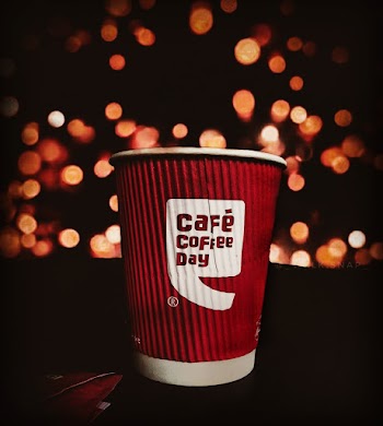 Selective Focus Photo of Red and white Cafe Coffee Day Disposable Paper  Cup