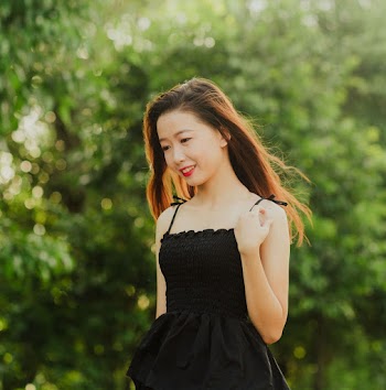 Selective Focus Photo of Smiling Woman Walking Alone