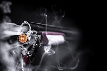 Selective Focus Photo of Smoking Shotgun