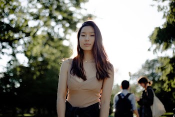 Selective Focus Photo of Standing Woman in Brown Spaghetti Strap Top Posing