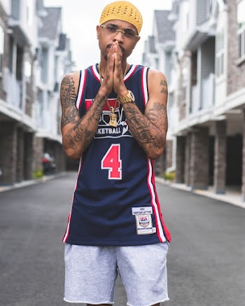 Selective Focus Photo of Tattooed Man in Basketball Jersey Posing